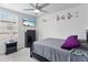Bedroom with decorative flower accents, a wall-mounted TV, and a ceiling fan at 39024 Harlow Rose Dr, Zephyrhills, FL 33540
