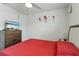 Comfortable bedroom showcasing a mounted flat screen tv and flower decor at 39024 Harlow Rose Dr, Zephyrhills, FL 33540