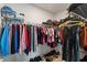 Organized walk-in closet with ample storage space for clothing and shoes at 39024 Harlow Rose Dr, Zephyrhills, FL 33540
