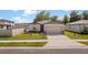Charming single-story home features a two-car garage, well-maintained lawn, and lovely landscaping at 39024 Harlow Rose Dr, Zephyrhills, FL 33540