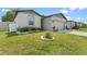 This house boasts a manicured front yard and well-maintained landscaping at 39024 Harlow Rose Dr, Zephyrhills, FL 33540