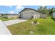 Charming single-story home featuring a well-manicured lawn, neutral paint, and attached two-car garage at 39024 Harlow Rose Dr, Zephyrhills, FL 33540