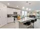 Well-lit kitchen with granite island, stainless steel appliances, and bar stool seating at 39024 Harlow Rose Dr, Zephyrhills, FL 33540
