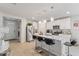 Spacious kitchen featuring a large island, stainless steel appliances, and modern pendant lights at 39024 Harlow Rose Dr, Zephyrhills, FL 33540