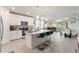 Open-concept kitchen with stainless steel appliances, granite countertops, island, and breakfast bar at 39024 Harlow Rose Dr, Zephyrhills, FL 33540