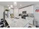 Modern kitchen featuring granite counters, stainless steel appliances, and an island with seating at 39024 Harlow Rose Dr, Zephyrhills, FL 33540