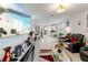 Open-concept living space featuring tile floors, a large-screen TV, and a seamless flow into the kitchen at 39024 Harlow Rose Dr, Zephyrhills, FL 33540