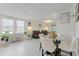 Bright living room features recessed lighting, tile flooring, and an adjacent dining area with modern furnishings at 39024 Harlow Rose Dr, Zephyrhills, FL 33540