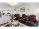 Modern living room with leather reclining chairs, stylish decor, and lots of natural light at 39024 Harlow Rose Dr, Zephyrhills, FL 33540