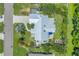 Stunning aerial view of property with lush landscaping, pool, and modern metal roof at 4096 38Th S St, St Petersburg, FL 33711