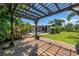 Backyard boasts a wooden pergola and outdoor seating, ideal for entertaining and relaxation at 4096 38Th S St, St Petersburg, FL 33711