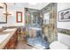 Unique bathroom with a tiled shower, hardwood cabinets, and double sinks at 4096 38Th S St, St Petersburg, FL 33711