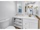 Bright bathroom features a white vanity with gold accents and stylish shelving for storage at 4096 38Th S St, St Petersburg, FL 33711