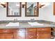 Bathroom with double sink, tiled countertop and mosaic backsplash, framed mirrors and sconce lighting at 4096 38Th S St, St Petersburg, FL 33711