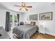 Cozy bedroom with a ceiling fan, desk, and access to the outdoors through french doors at 4096 38Th S St, St Petersburg, FL 33711