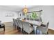 Spacious dining room featuring wood floors, a large table, and a bay window providing natural light at 4096 38Th S St, St Petersburg, FL 33711