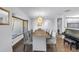 Bright and open dining room with hardwood floors, a modern chandelier, and a piano, perfect for entertaining at 4096 38Th S St, St Petersburg, FL 33711