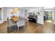 Bright dining room with hardwood floors, a modern chandelier, and an open layout connected to the kitchen and living area at 4096 38Th S St, St Petersburg, FL 33711