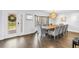 Dining area with wood floors, a large table with seating for eight, and a bay window for natural light at 4096 38Th S St, St Petersburg, FL 33711