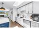 Bright kitchen featuring white cabinets, stainless steel appliances, and a skylight at 4096 38Th S St, St Petersburg, FL 33711