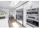 Modern kitchen with stainless steel refrigerator and built in oven, open to a dining area at 4096 38Th S St, St Petersburg, FL 33711
