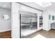Kitchen featuring stainless steel refrigerator and double ovens with white cabinets at 4096 38Th S St, St Petersburg, FL 33711