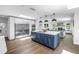 Modern kitchen featuring a blue island, stainless steel appliances, and an open layout to the living area at 4096 38Th S St, St Petersburg, FL 33711