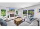 Bright living room with a fireplace, hardwood floors, and sliding glass doors to the backyard at 4096 38Th S St, St Petersburg, FL 33711