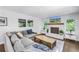 Spacious living room with hardwood floors, large windows, and a comfortable sectional sofa at 4096 38Th S St, St Petersburg, FL 33711