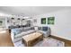Open concept living room with hardwood floors, sofa, and view of the kitchen bar seating at 4096 38Th S St, St Petersburg, FL 33711
