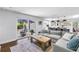 Inviting living room with backyard view from sliding door, hardwood floors, and view of the kitchen at 4096 38Th S St, St Petersburg, FL 33711