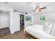 Bright main bedroom with hardwood floors, walk-in closet, ceiling fan, and backyard view at 4096 38Th S St, St Petersburg, FL 33711