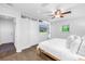 Well-lit main bedroom with hardwood floors, closet, ceiling fan, and backyard view at 4096 38Th S St, St Petersburg, FL 33711