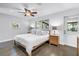 Comfortable main bedroom with a ceiling fan, hardwood floors, and backyard view at 4096 38Th S St, St Petersburg, FL 33711