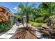 An outdoor patio with cozy seating, complemented by lush tropical landscaping, and a charming, patterned stone design at 4096 38Th S St, St Petersburg, FL 33711