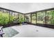 Enclosed patio featuring a patterned rug, plants, and view of landscaped backyard at 4096 38Th S St, St Petersburg, FL 33711