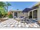 Relaxing patio features comfortable outdoor seating around a fire pit, complemented by vibrant flora at 4096 38Th S St, St Petersburg, FL 33711