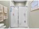 Bathroom showing an enclosed shower with tiled surround and glass doors at 4103 Via Piedra Cir # 10-101, Sarasota, FL 34233