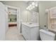 Bathroom with vanity, toilet, and door open to bedroom at 4103 Via Piedra Cir # 10-101, Sarasota, FL 34233