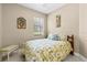 Cozy bedroom featuring a large window for ample natural light, complemented by quaint beach themed decor at 4103 Via Piedra Cir # 10-101, Sarasota, FL 34233