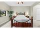 Comfortable bedroom features a wrought iron bed, neutral walls, and tiled floors at 4103 Via Piedra Cir # 10-101, Sarasota, FL 34233