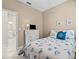Serene guest bedroom featuring a bed with sea-themed decor, white dresser, and ensuite bathroom access at 4103 Via Piedra Cir # 10-101, Sarasota, FL 34233