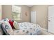 Comfortable bedroom with beach-themed decor, a window for natural light and a closet for extra storage at 4103 Via Piedra Cir # 10-101, Sarasota, FL 34233