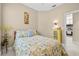 Well-lit bedroom with neutral walls, offering a serene space with comfortable furnishings and beach-themed decor at 4103 Via Piedra Cir # 10-101, Sarasota, FL 34233