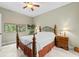 Cozy bedroom with natural light, ceiling fan, and a wrought iron-style bed at 4103 Via Piedra Cir # 10-101, Sarasota, FL 34233