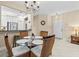 Charming dining area with a glass-top table, wicker chairs, and a stylish chandelier at 4103 Via Piedra Cir # 10-101, Sarasota, FL 34233
