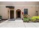 Close-up of the townhome entrance featuring an arched entryway and well-kept landscaping at 4103 Via Piedra Cir # 10-101, Sarasota, FL 34233