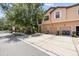 Beautiful townhome featuring three garage doors, complemented by mature trees and lush landscaping at 4103 Via Piedra Cir # 10-101, Sarasota, FL 34233