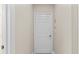 Hallway with neutral-toned walls, white trim, and a closed door for privacy and access to other areas at 4103 Via Piedra Cir # 10-101, Sarasota, FL 34233