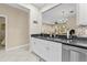 Well-lit kitchen with stainless steel dishwasher, granite counters, white cabinetry and decorative tile backsplash at 4103 Via Piedra Cir # 10-101, Sarasota, FL 34233